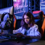 woman in white long sleeve shirt sitting on chair using black computer keyboard